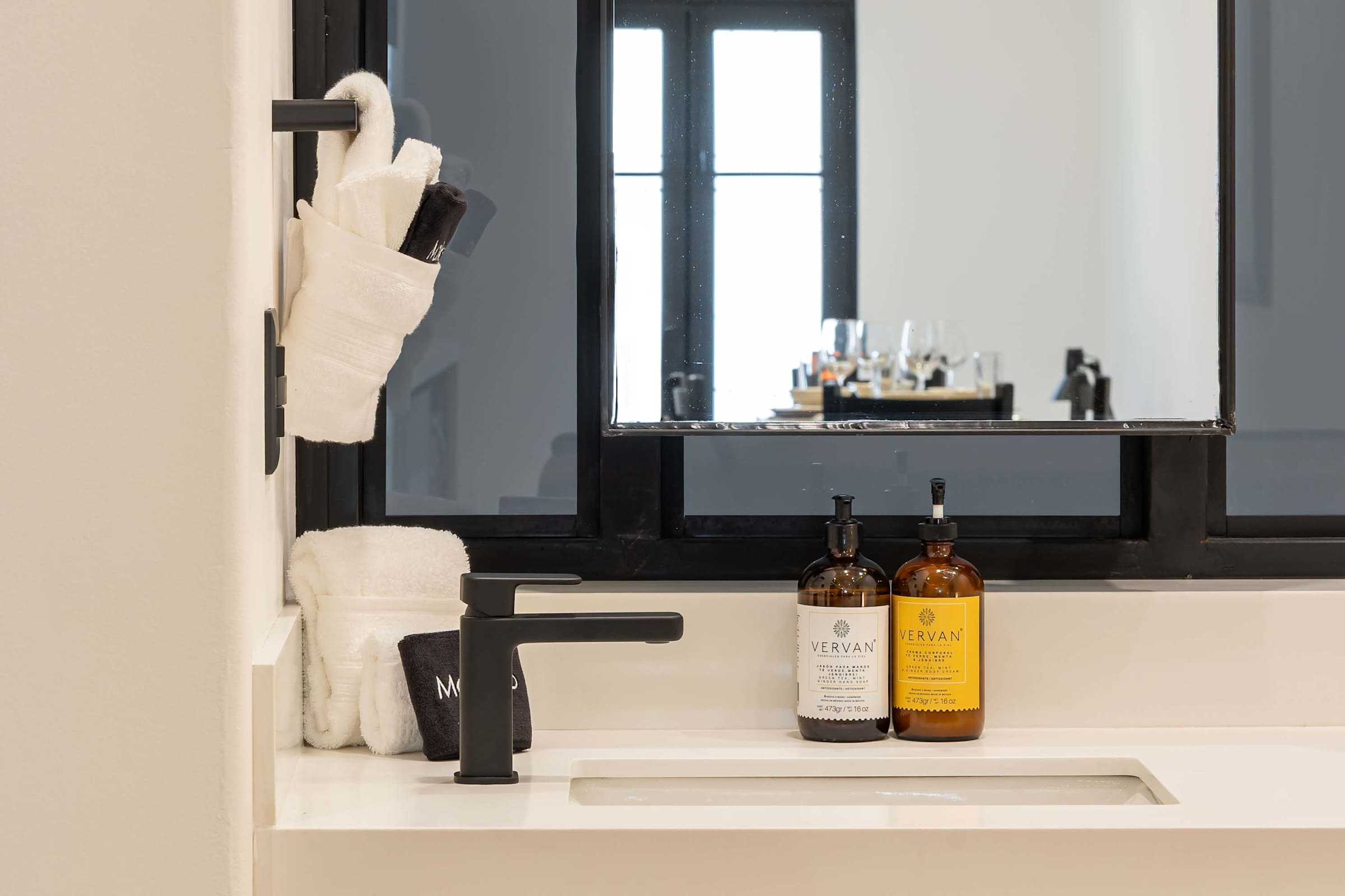 Bathroom vanity with fresh towels and premium toiletries
