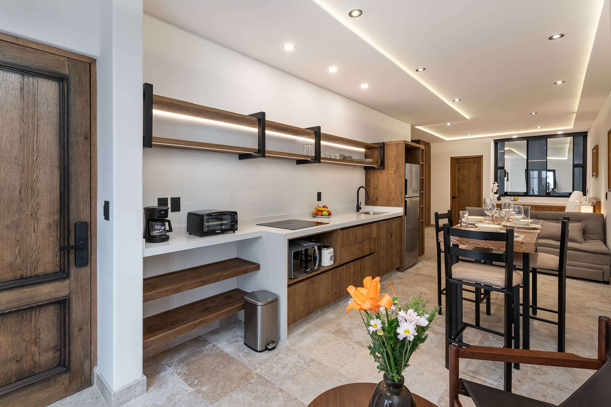 Fully equipped kitchen with wood cabinetry, appliances, and dining area