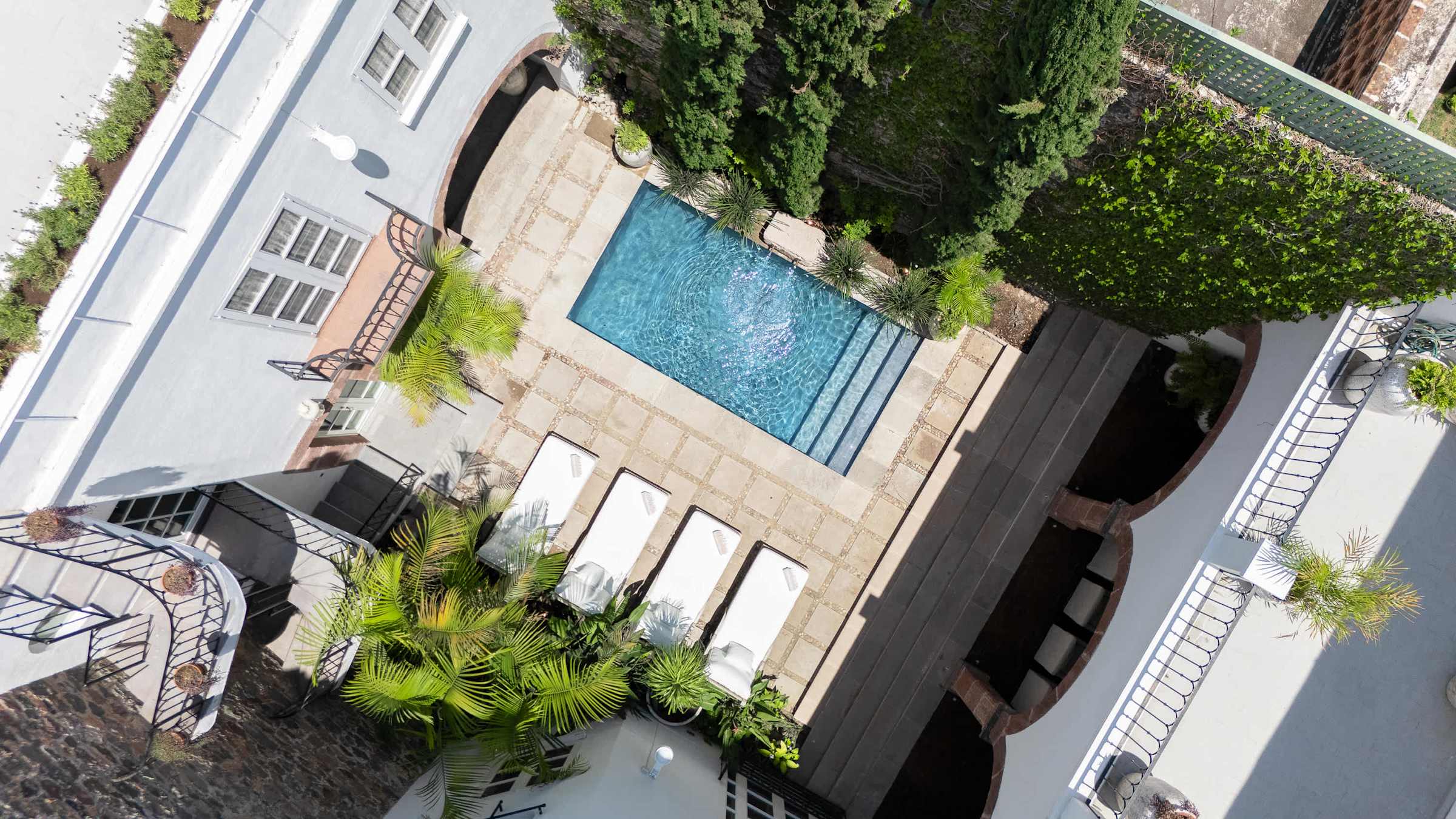 Aerial view of the pool courtyard surrounded by the estate
