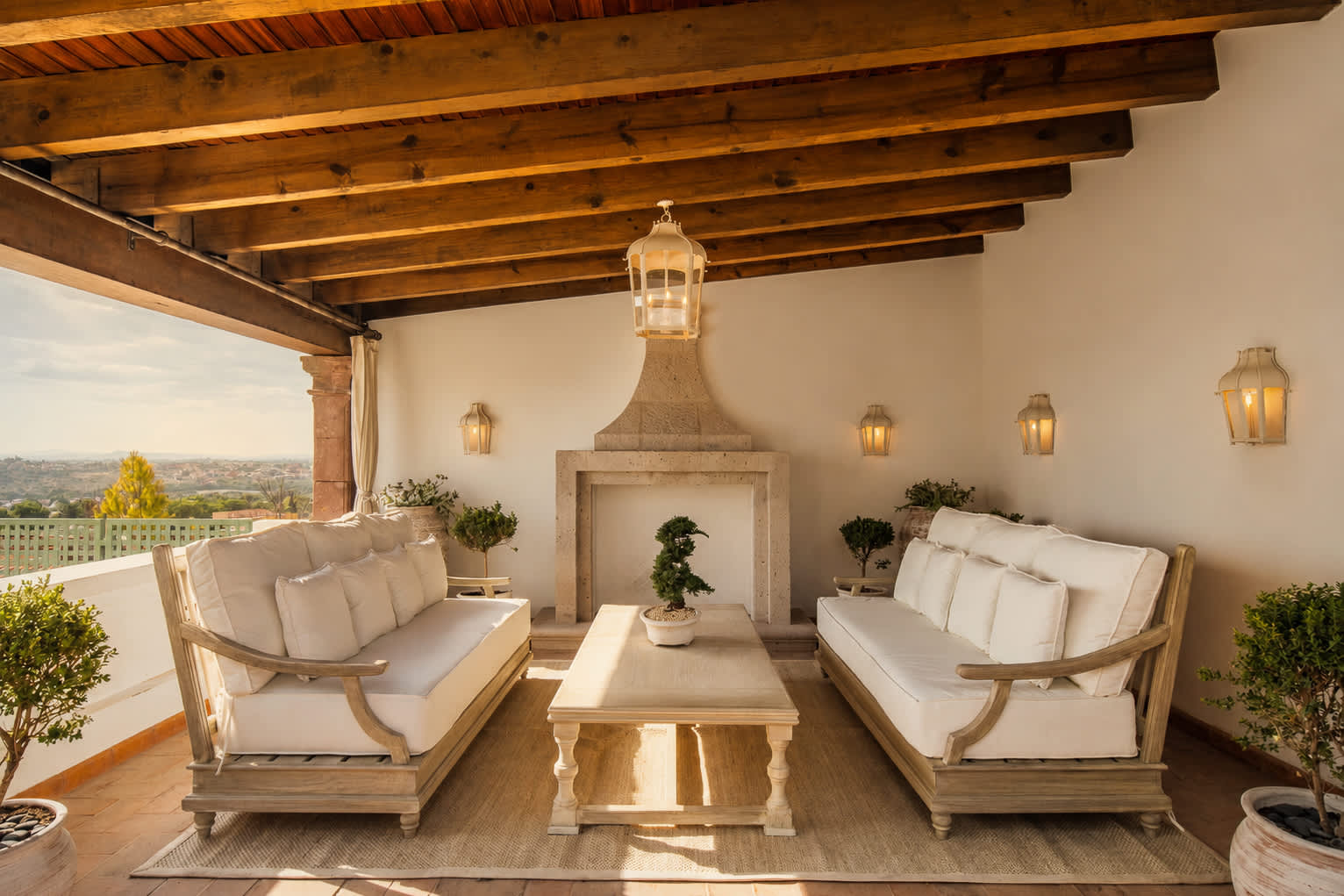 Rooftop lounge with outdoor fireplace and beamed ceiling