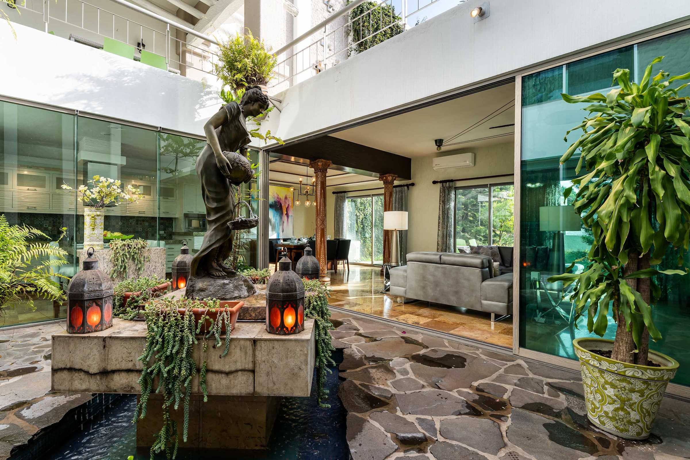 Inner courtyard walkway with greenery and fountain