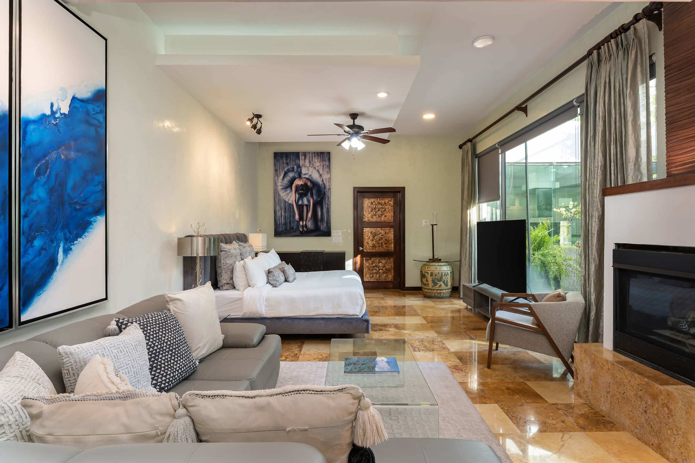 Primary suite sitting area with TV and fireplace