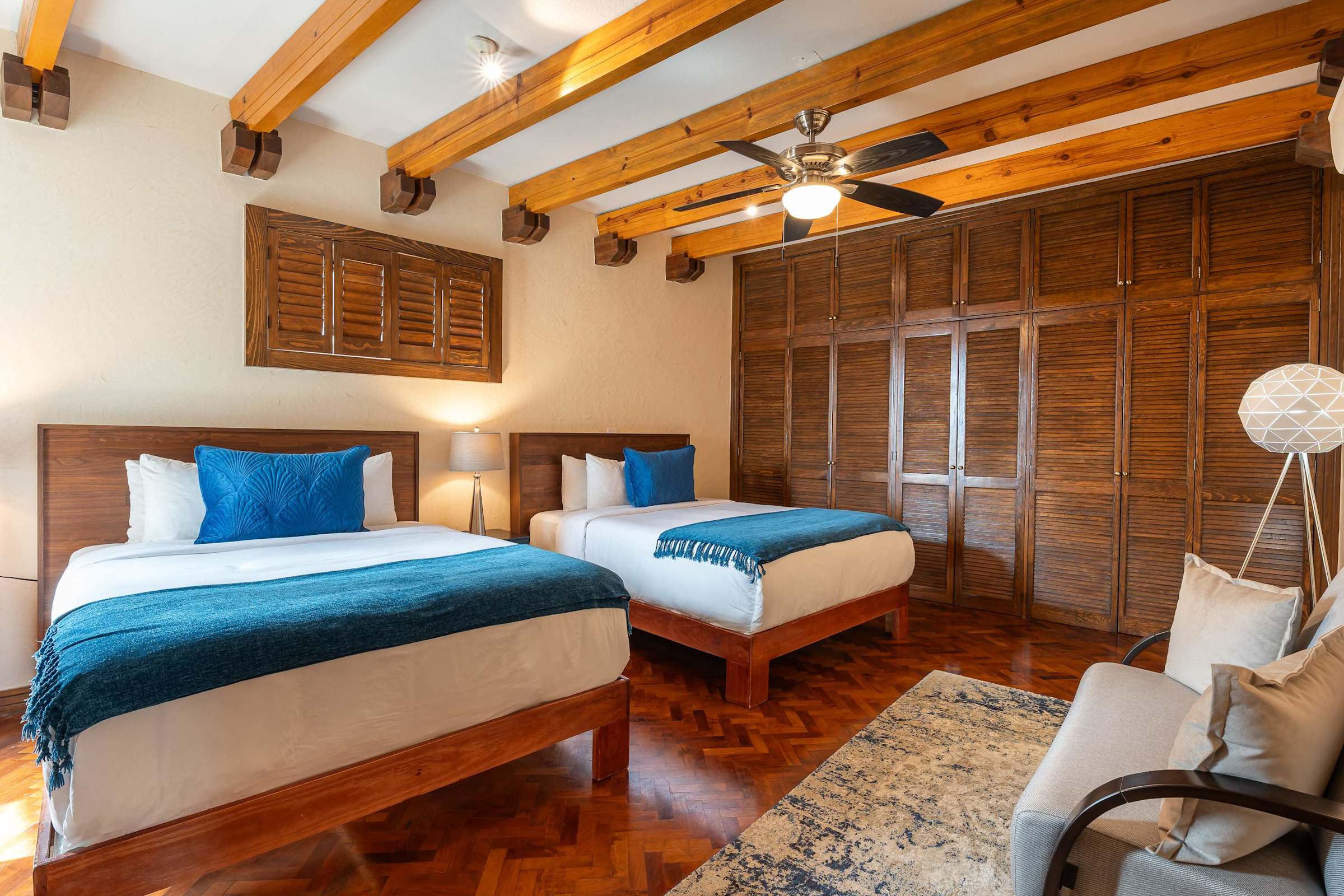 Guest bedroom with two double beds and wardrobe closet