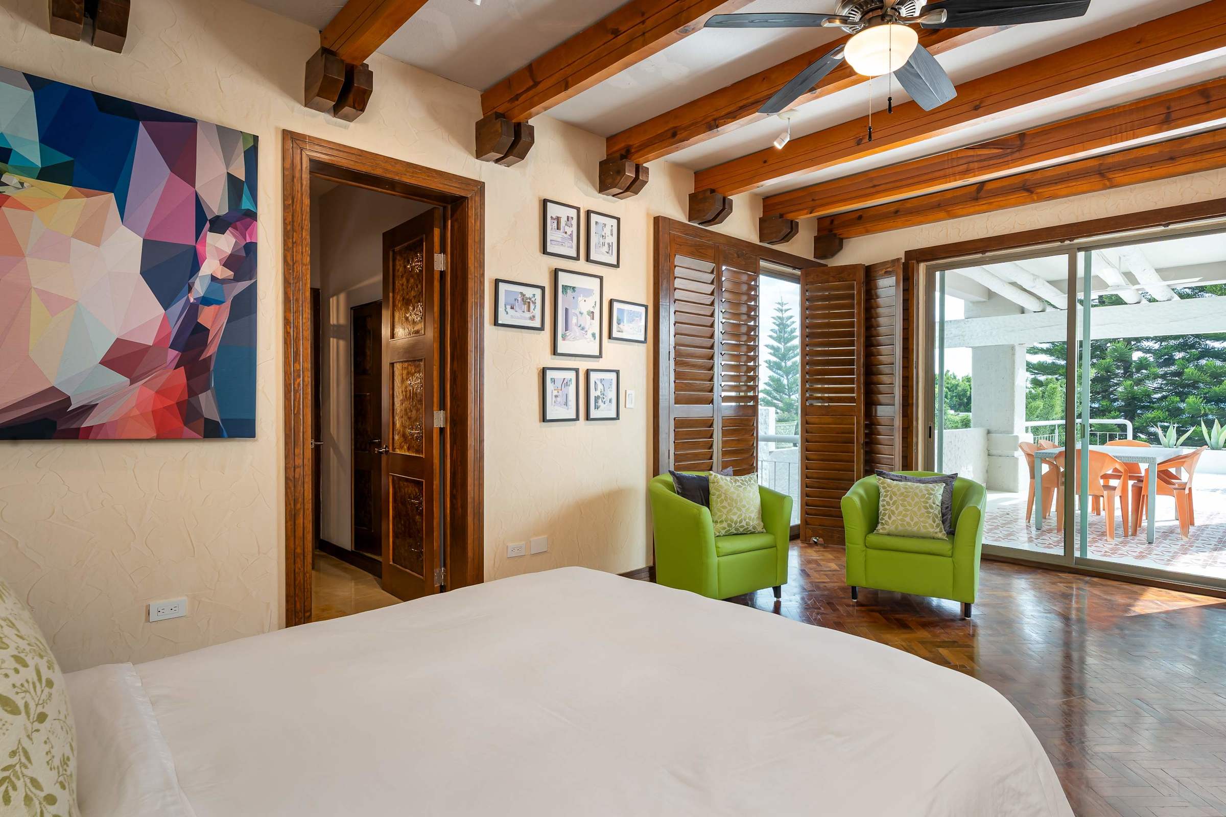 Guest bedroom with gallery wall art and patio