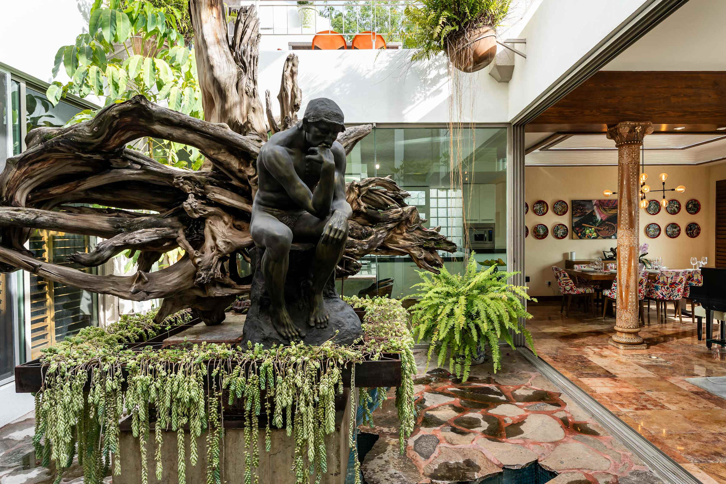 Inner sunroom patio with sculptural art and gardens
