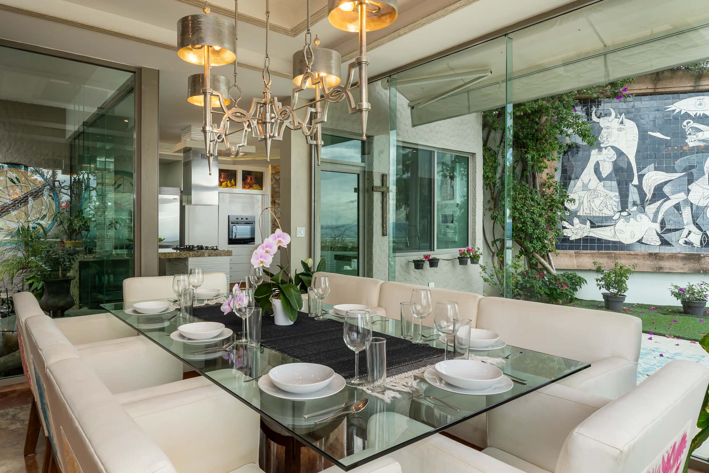 Formal dining area with chandelier and glass table