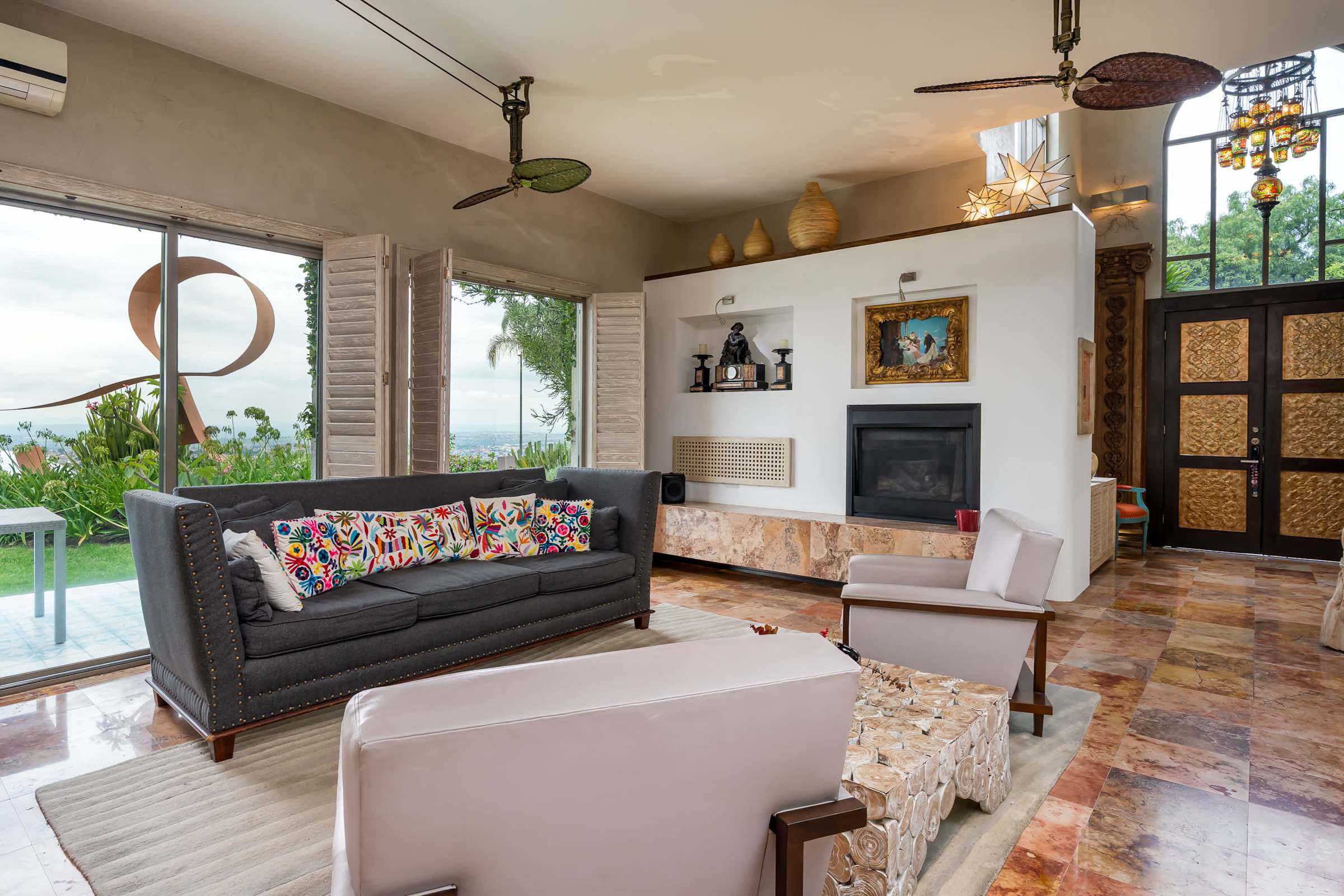 Living room with fireplace, sofa and garden views