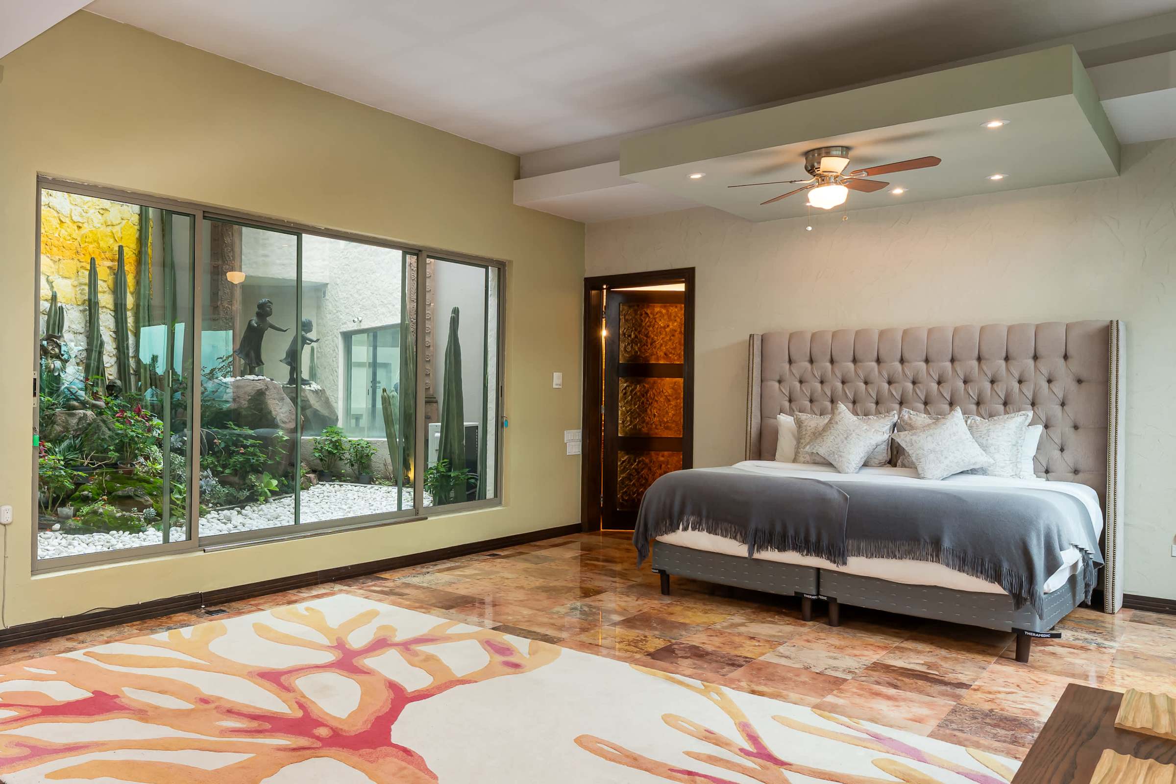 Primary bedroom with king bed and ceiling fan