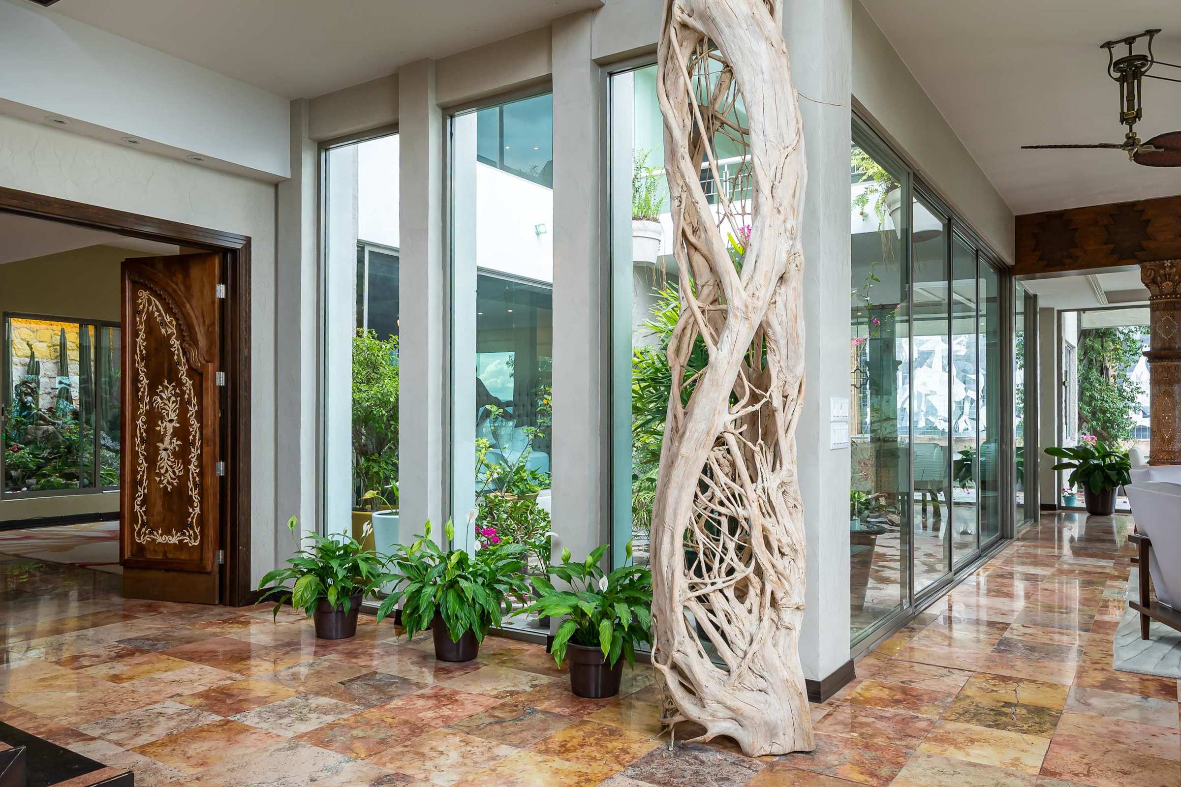 Front entrance with wooden door and garden pathway