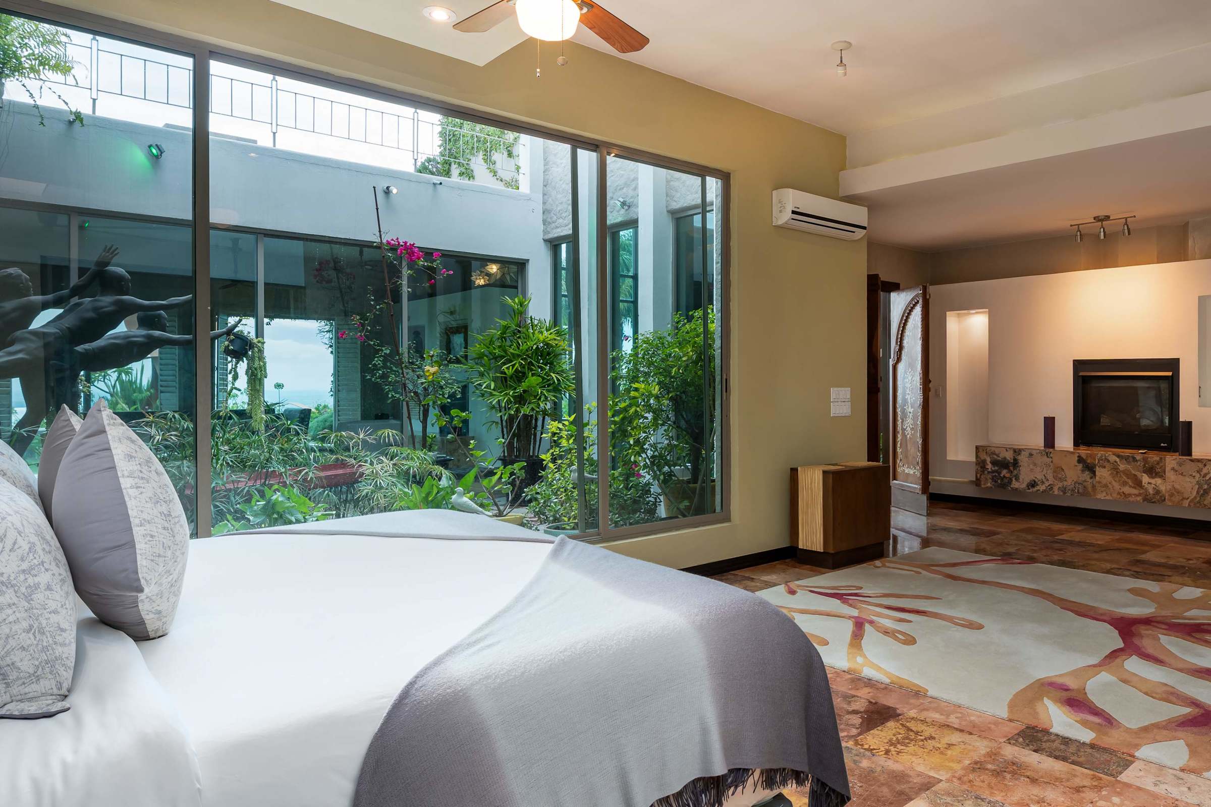 Primary bedroom with fireplace and garden views