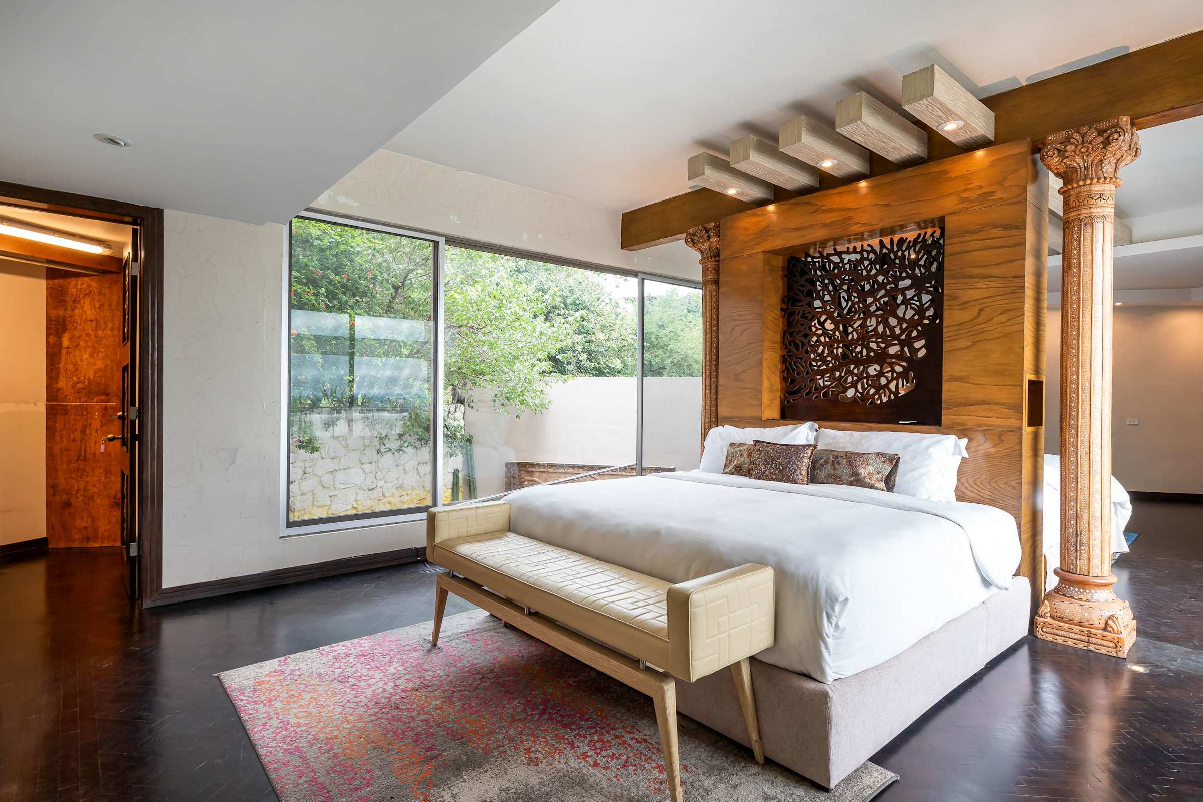 Guest suite king bed with wooden room divider
