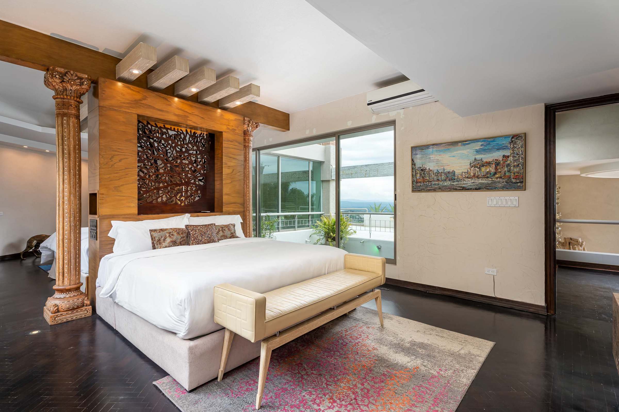 Guest suite king bed with hillside views