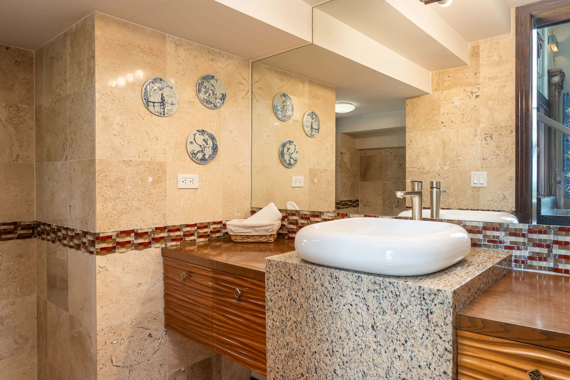 Guest bathroom with vanity and stone tile