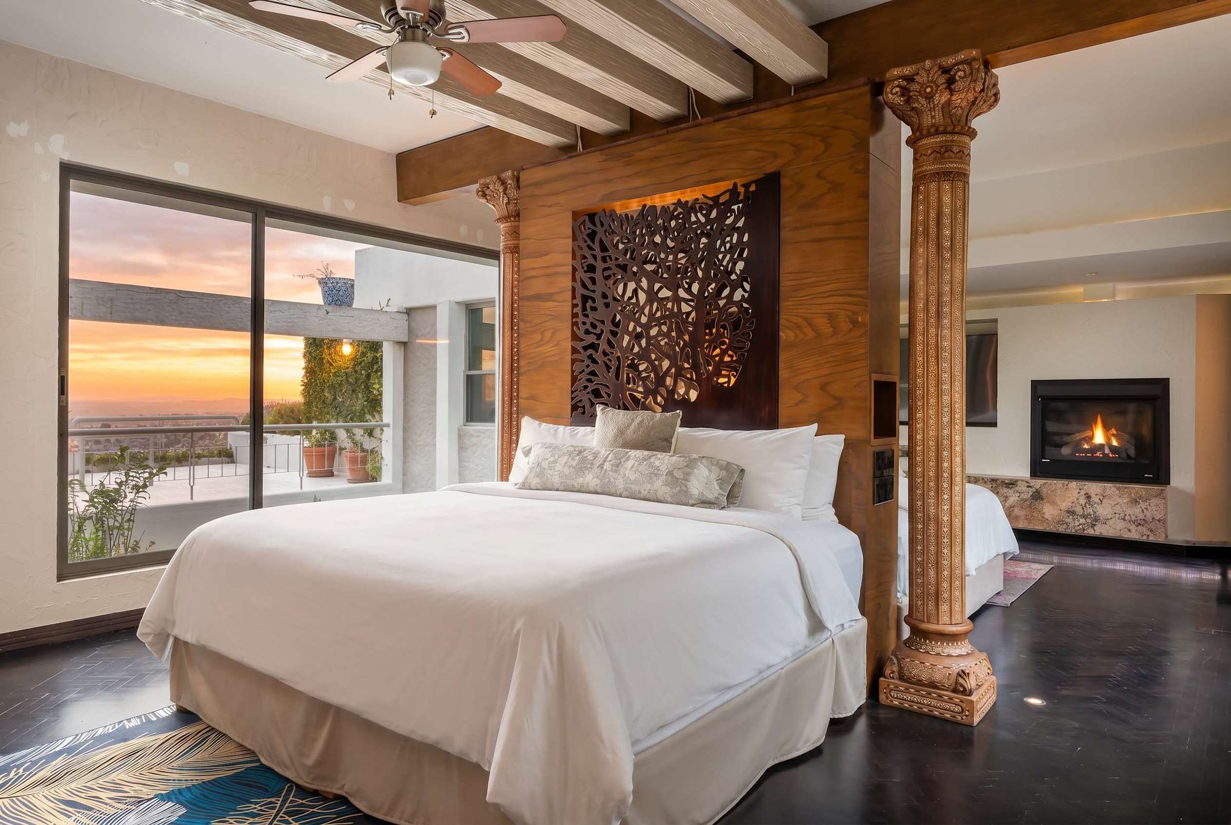 Double king beds with wooden room divider, fireplace and city views