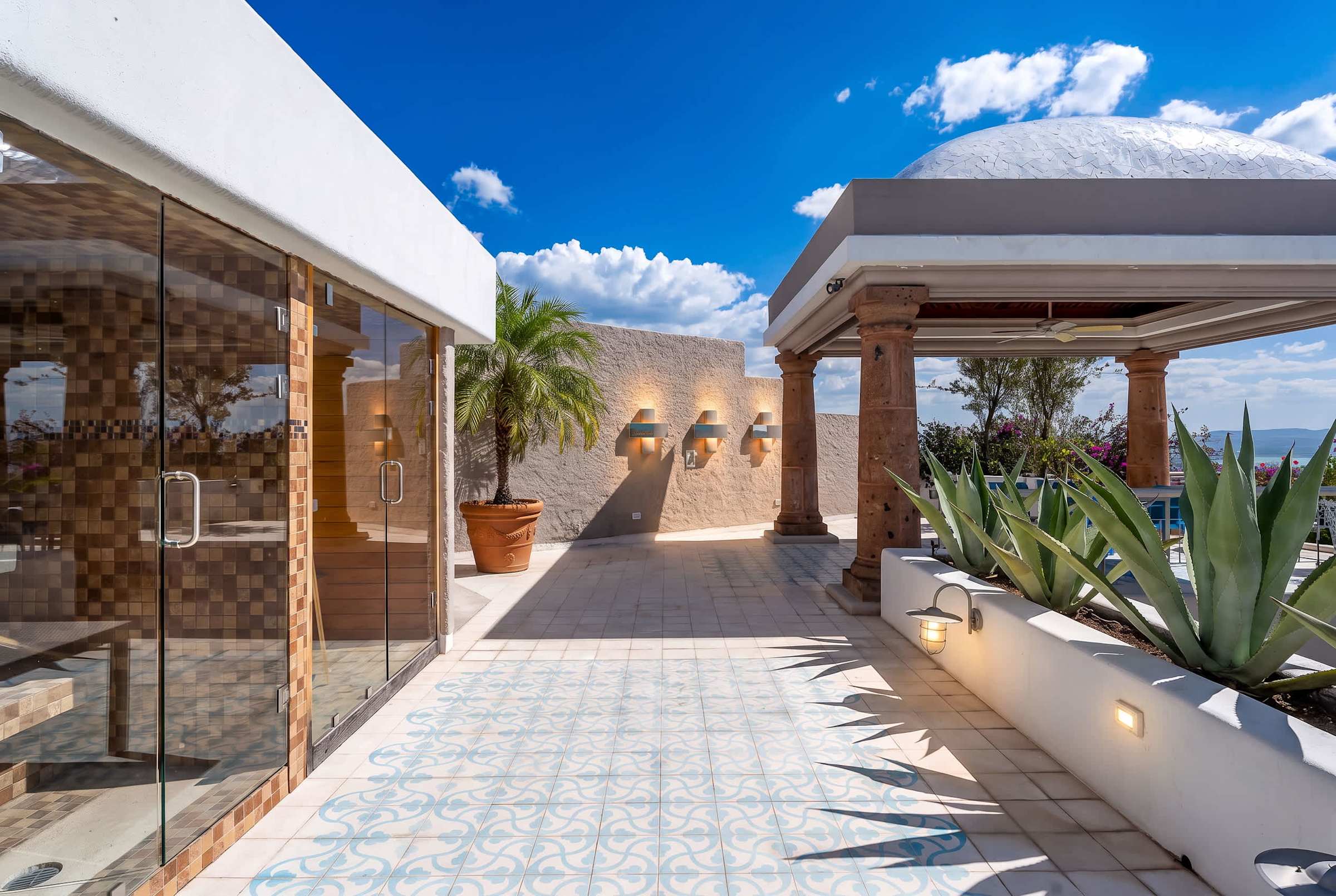 Top-level patio terrace with outdoor saunas and outdoor dining overlooking the city