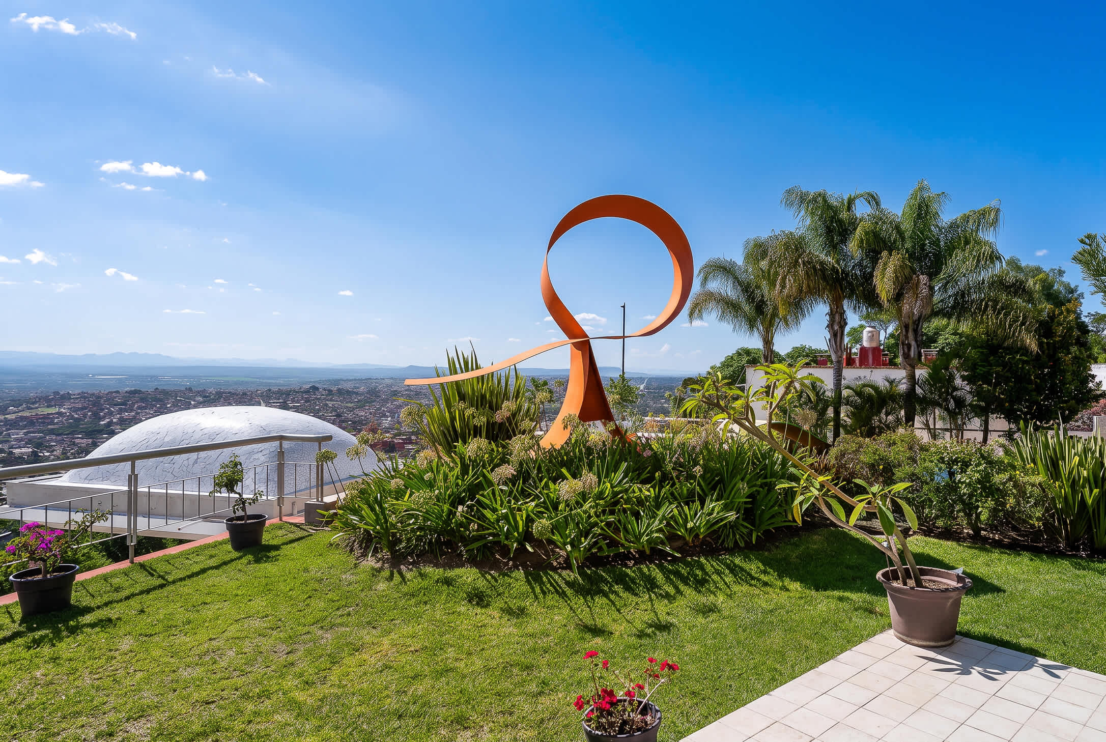 Outdoor patio that extends from the dining room and living room. Featuring a large architectural sculpture and panoramic views of San Miguel de Allende.