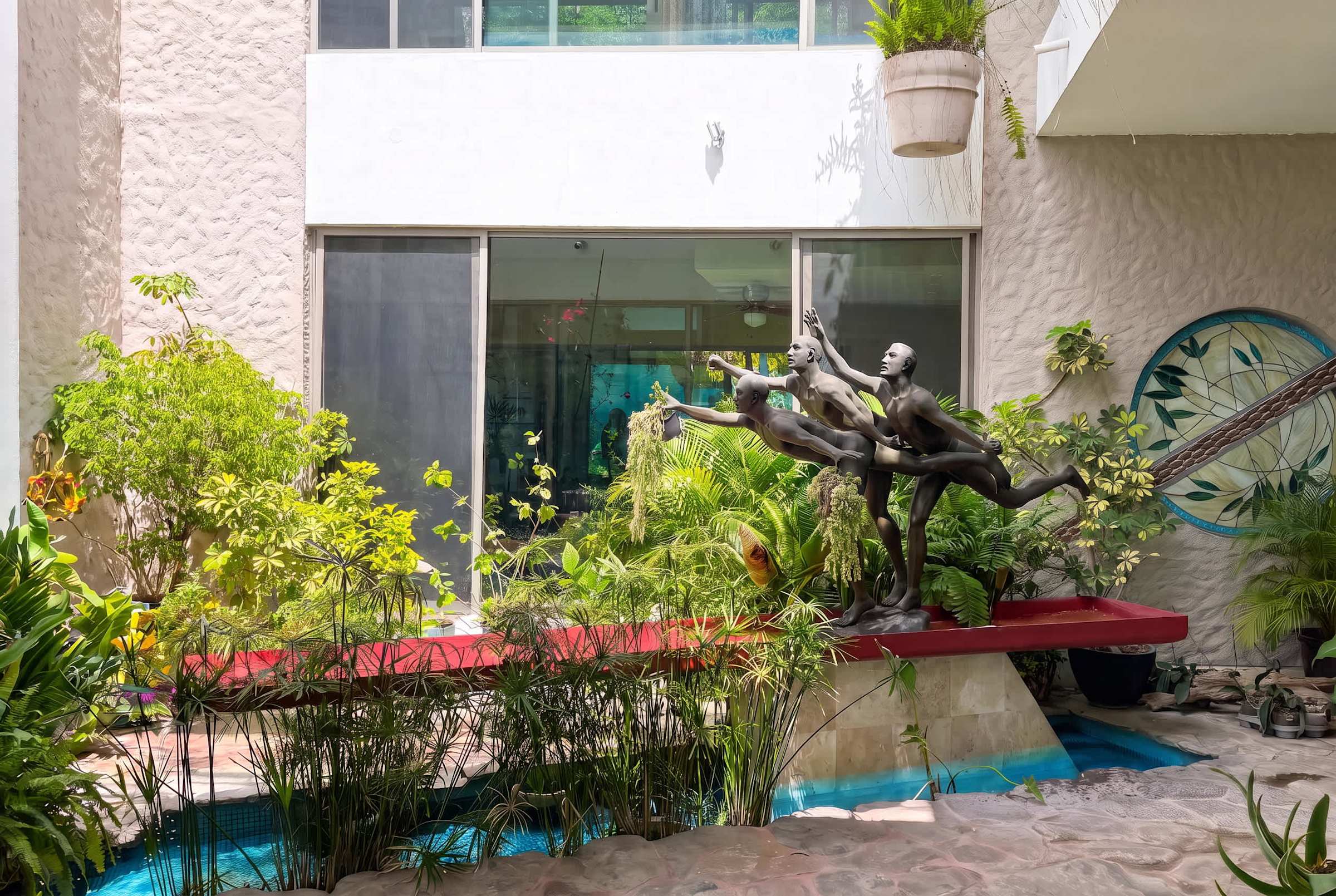 Inner sunroom patio with a fountain and sculpture