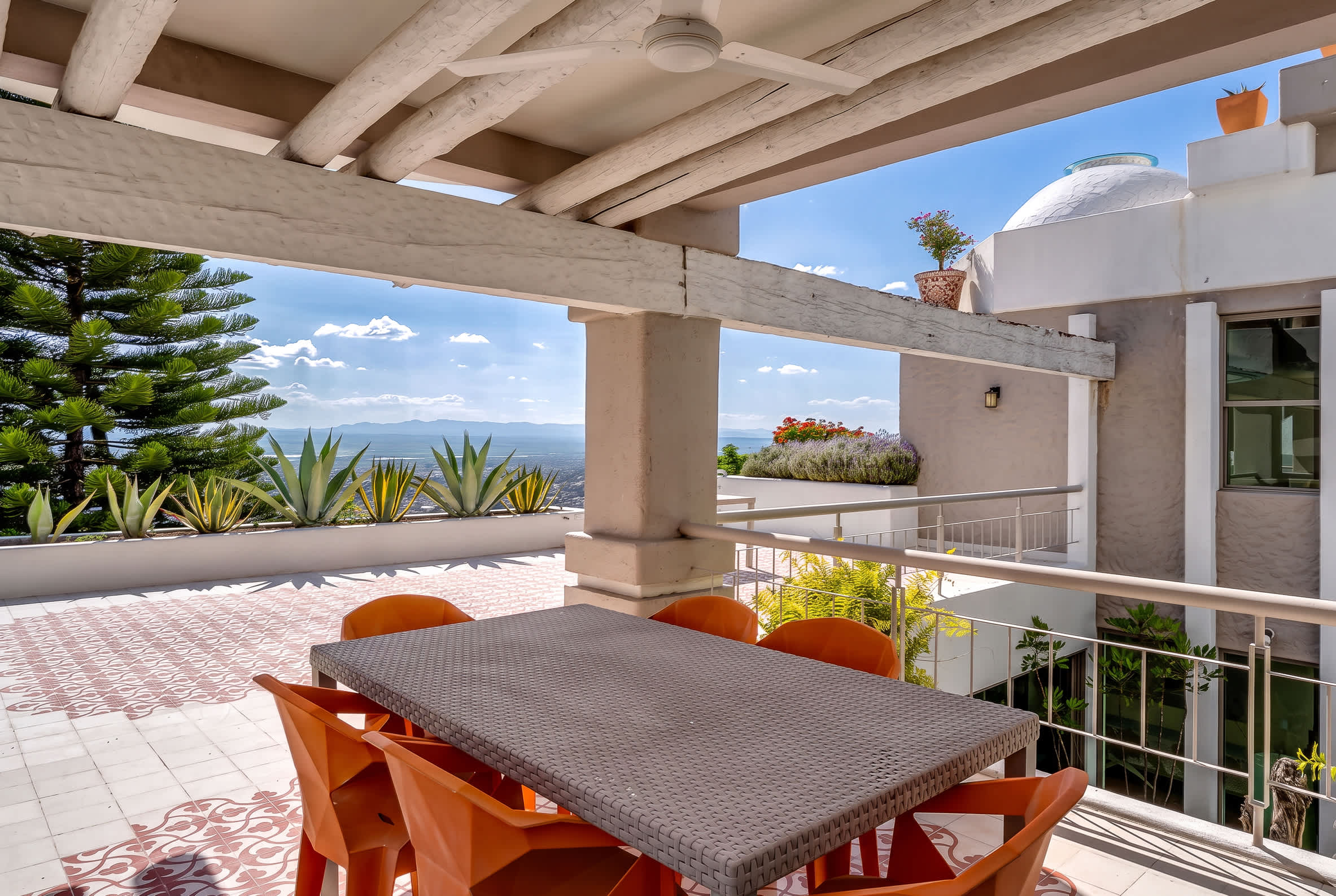 Second level patio with outdoor dining and an extended terrace