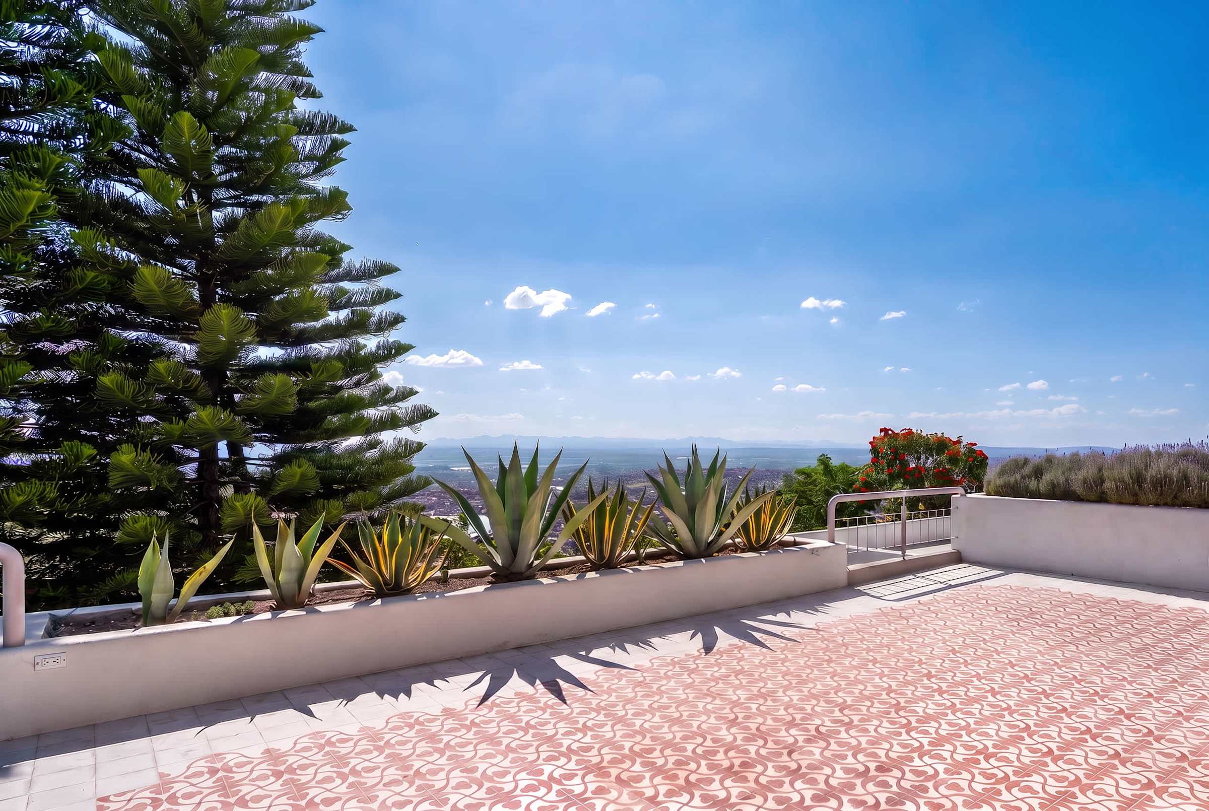 Second level patio with outdoor dining and an extended terrace