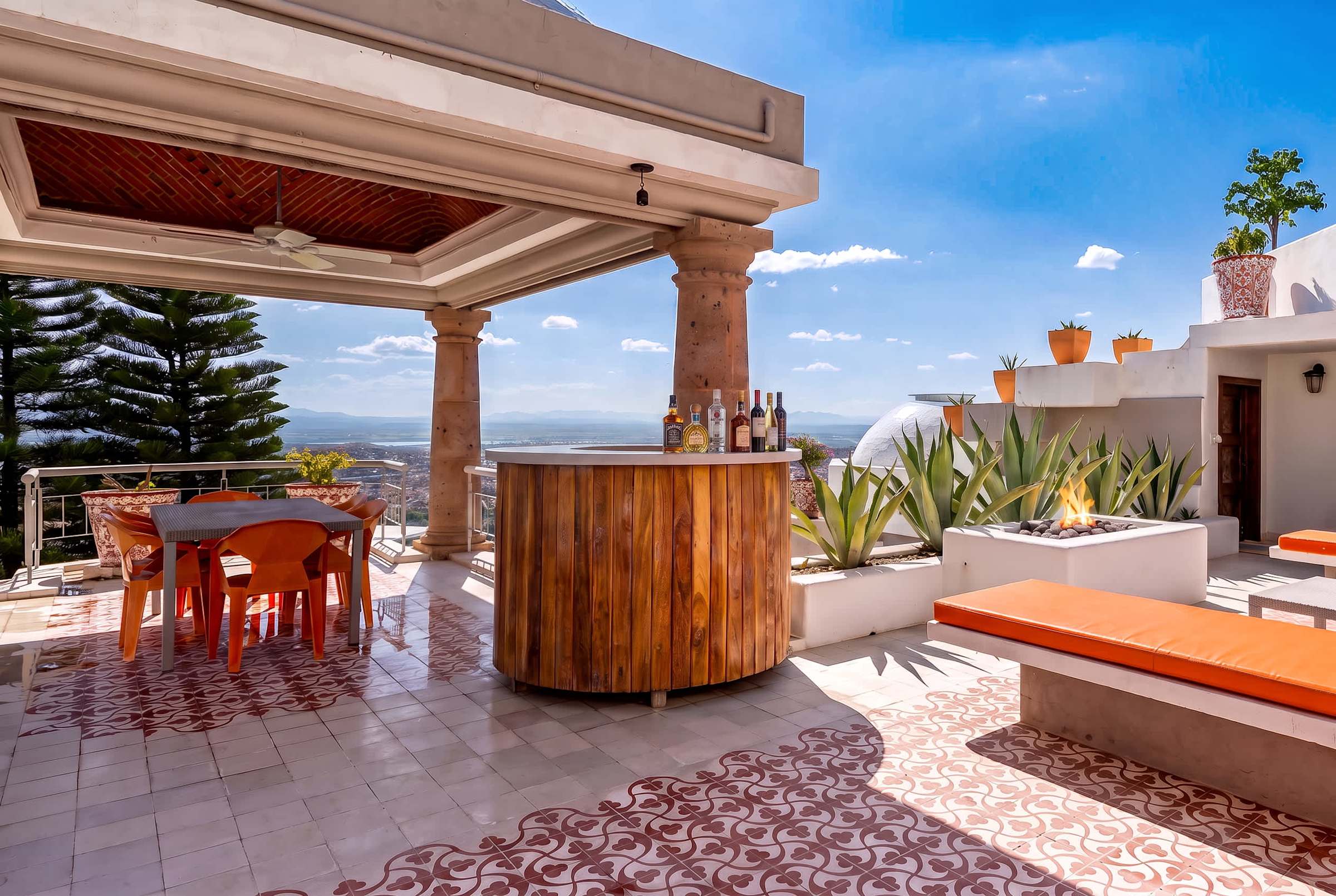 Top-level terrace with hot tub, fire pit, bar and outdoor dining area