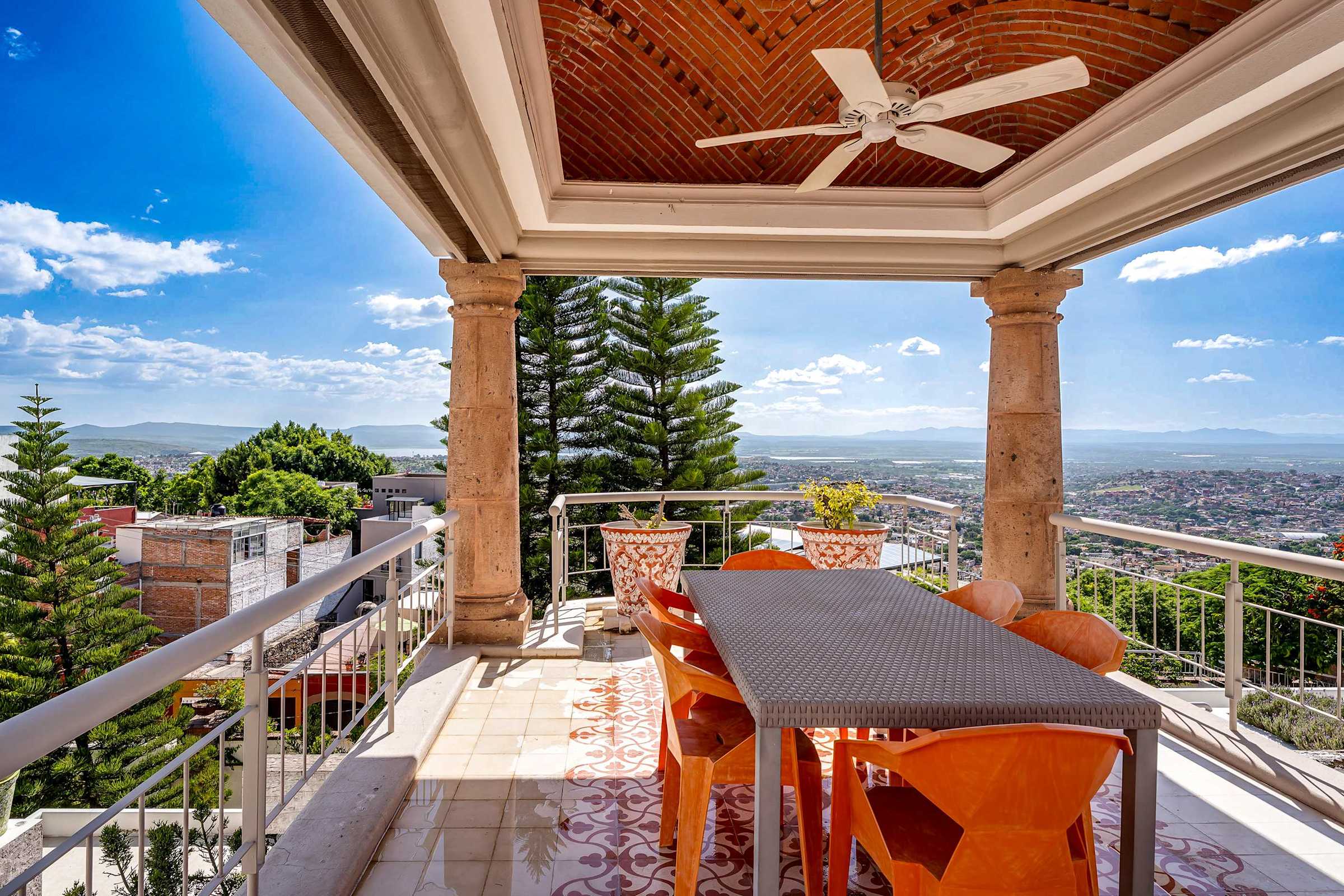 Top-level balcony views with outdoor dining