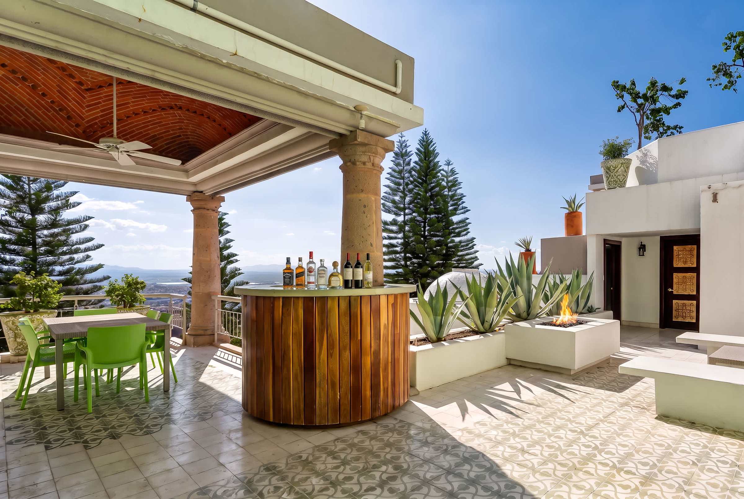 Second level terrace with lounge seating, bar, fire pit, hot tub and outdoor dining