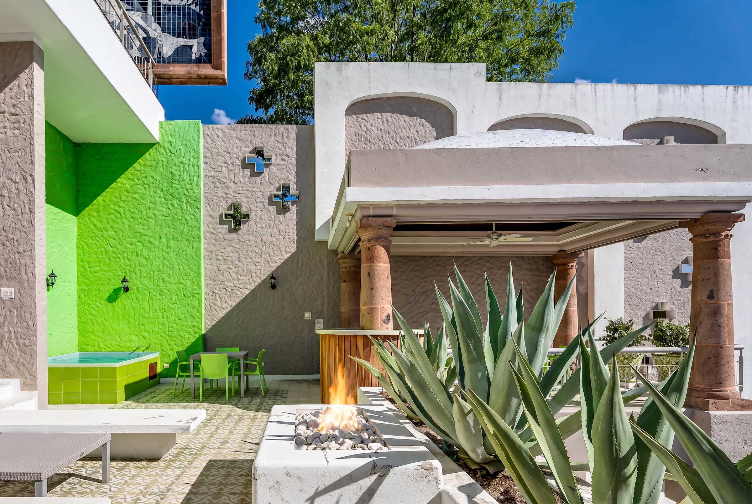 Second level terrace with lounge seating, fire pit, private hot tub and outdoor dining