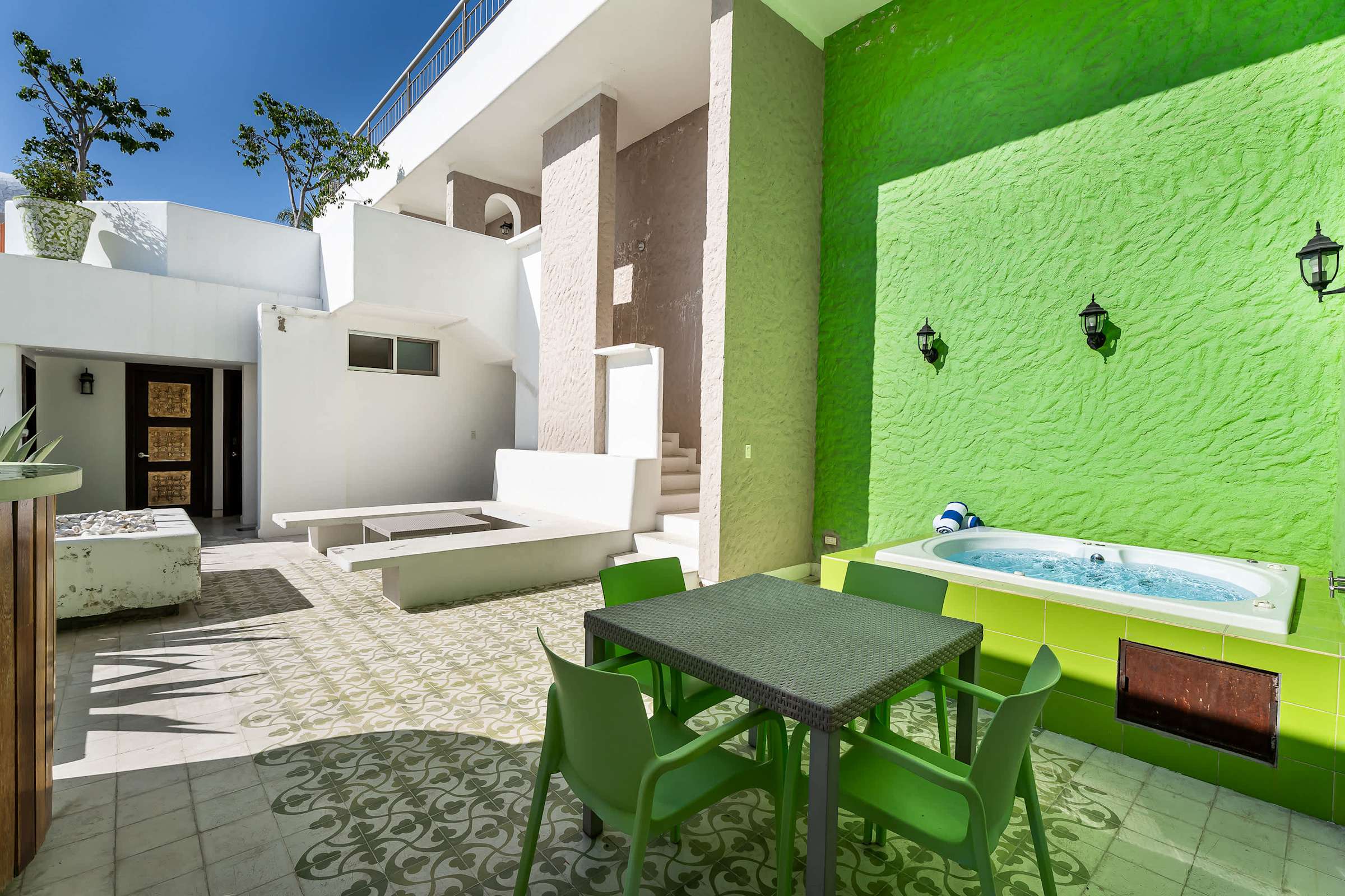 Second level terrace with lounge seating, fire pit, hot tub and outdoor dining