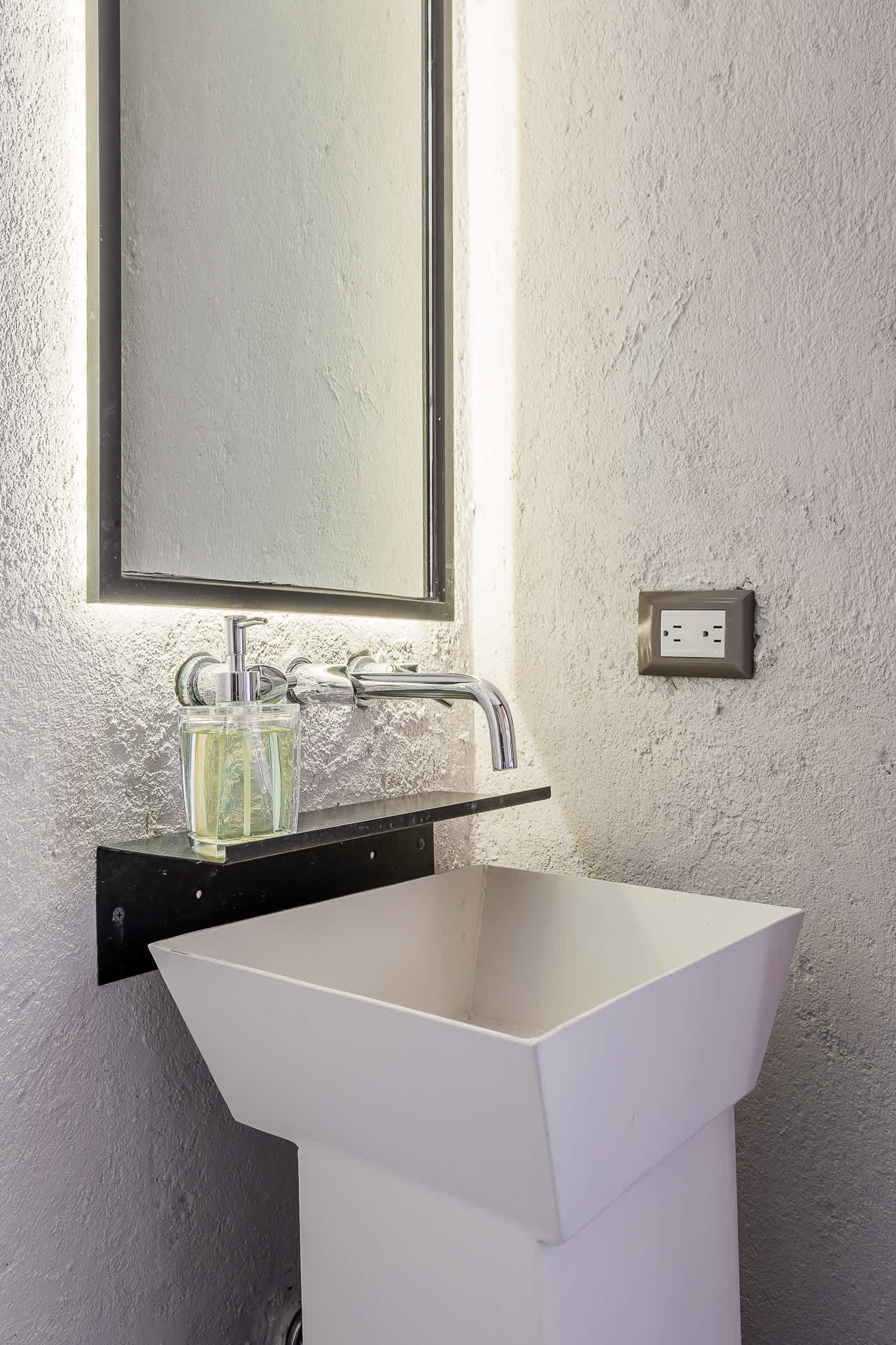 Half bathroom with a modern pedestal sink