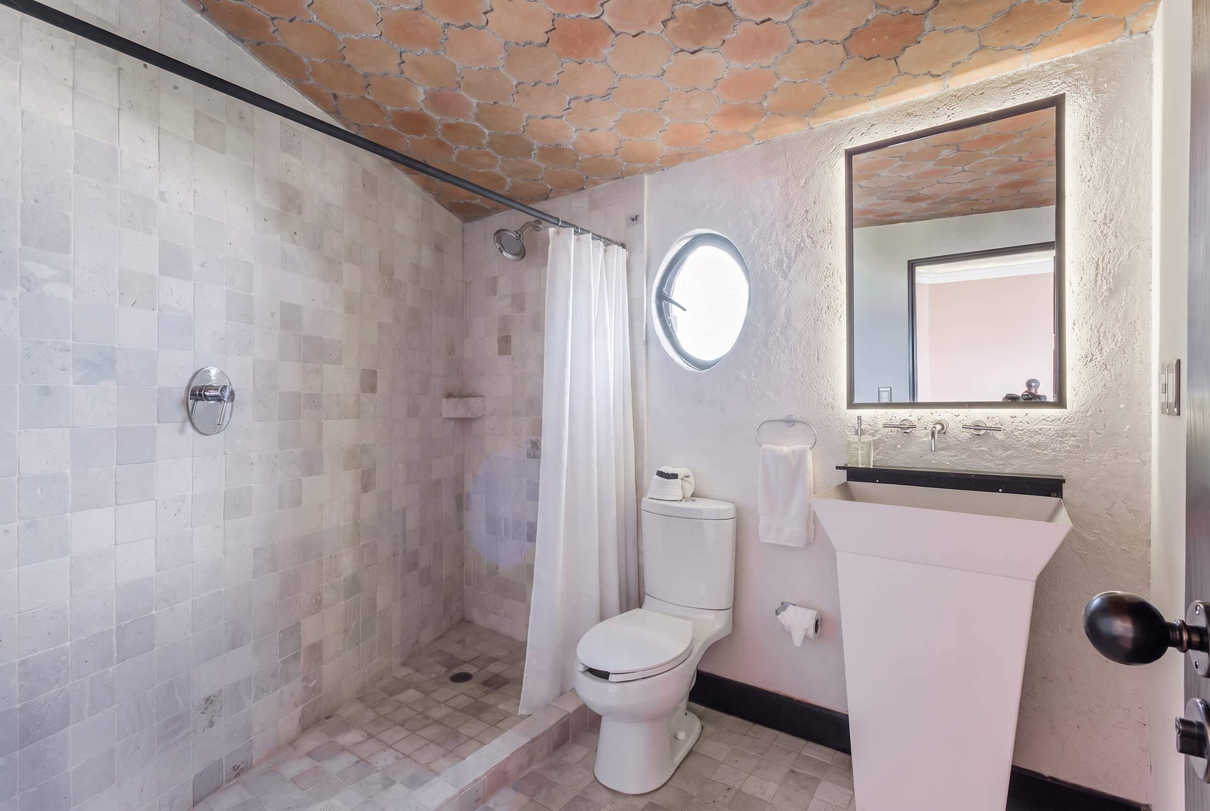 Ensuite bathroom with tiled walls and walk-in shower