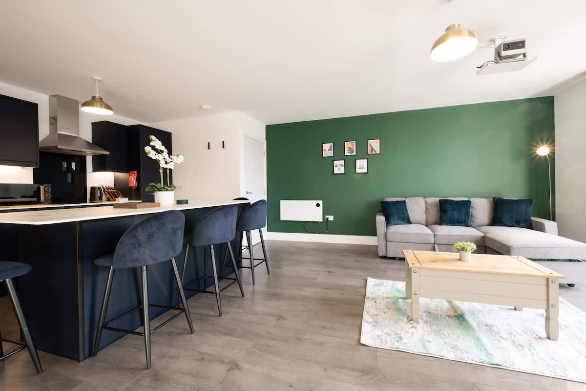 Open-plan kitchen, dining and living space with breakfast bar seating