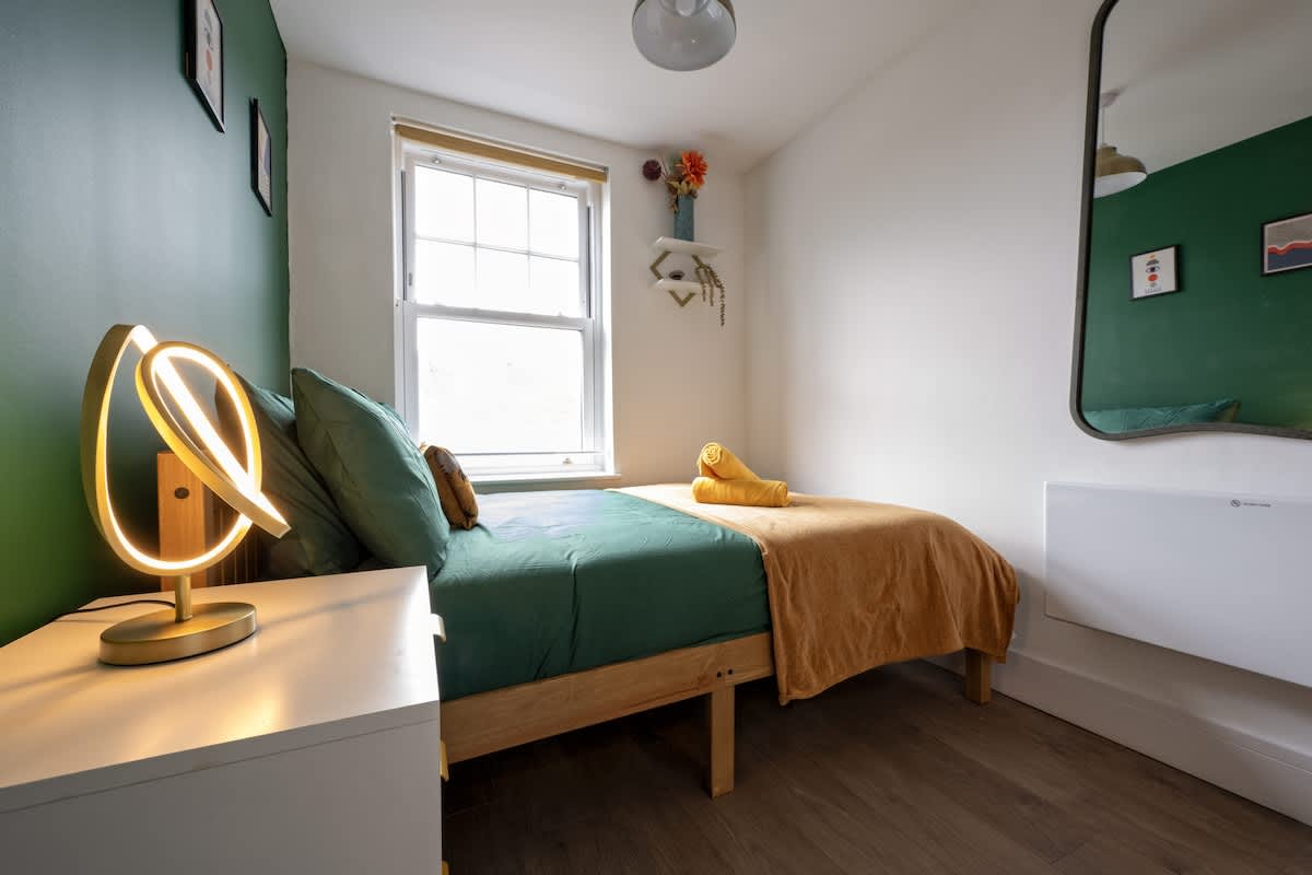Stylish second bedroom with double bed and natural light