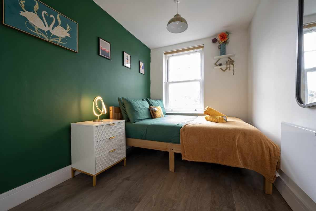 Bright bedroom with double bed and storage