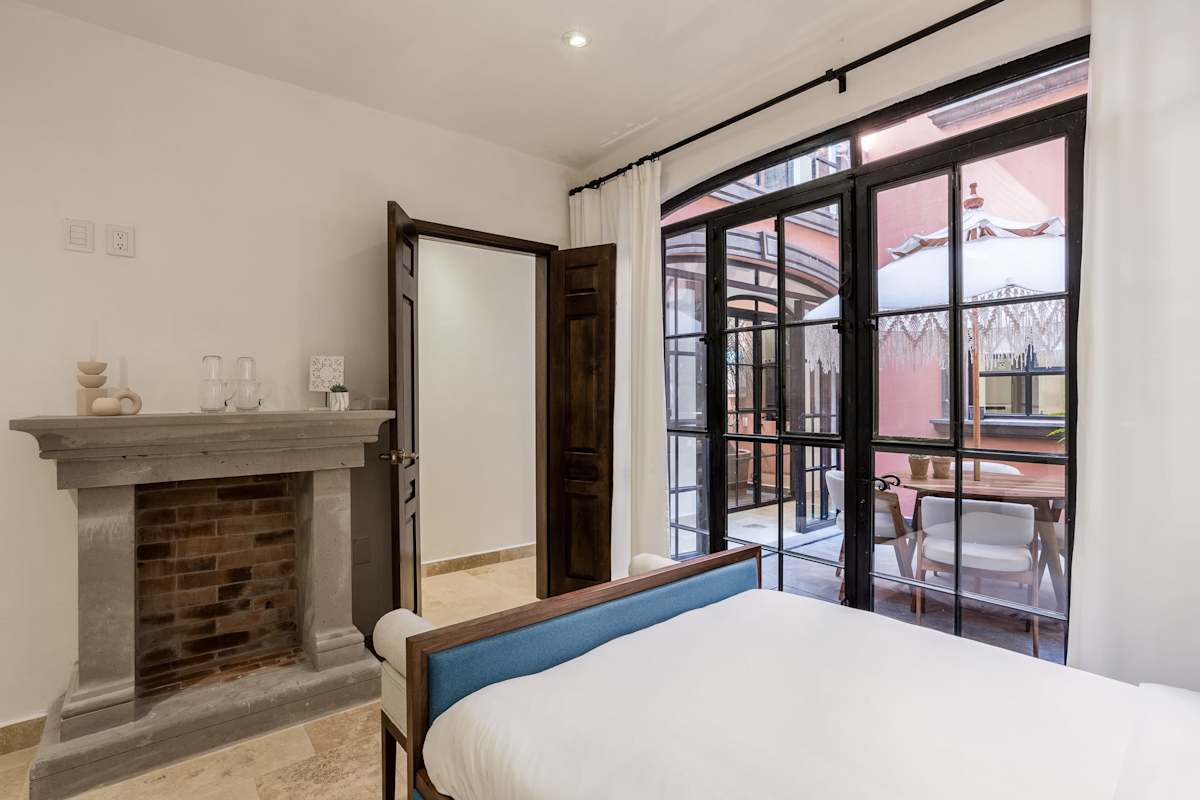 Bedroom with double beds and patio