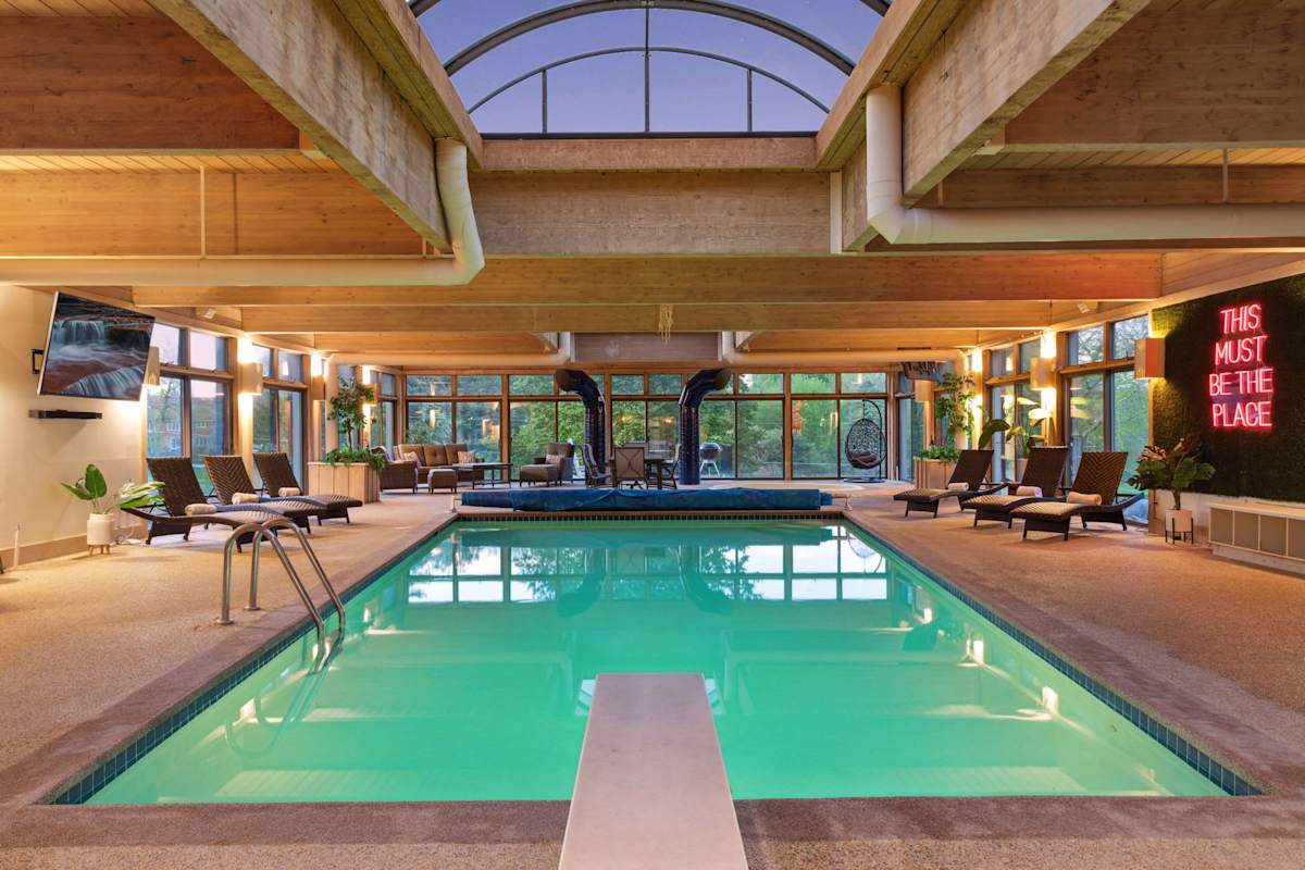 Dive into relaxation in this expansive indoor pool, where comfort meets luxury under the soothing embrace of natural light.