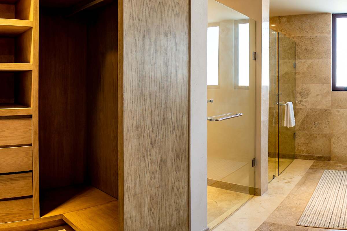 Full Bathroom 5 with a wood-panel vanity, step-in shower, and earthy warm-toned finishes