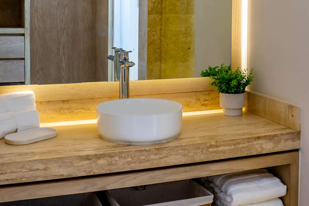 Full bathroom 3 with an illuminated stone vanity, round vessel sink, and premium toiletries