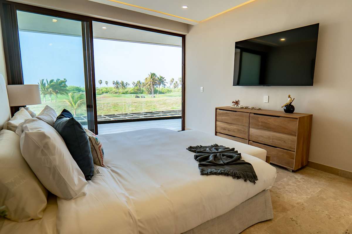 Bedroom 4 with a flat-screen TV, garden terrace access, and modern wood furnishings