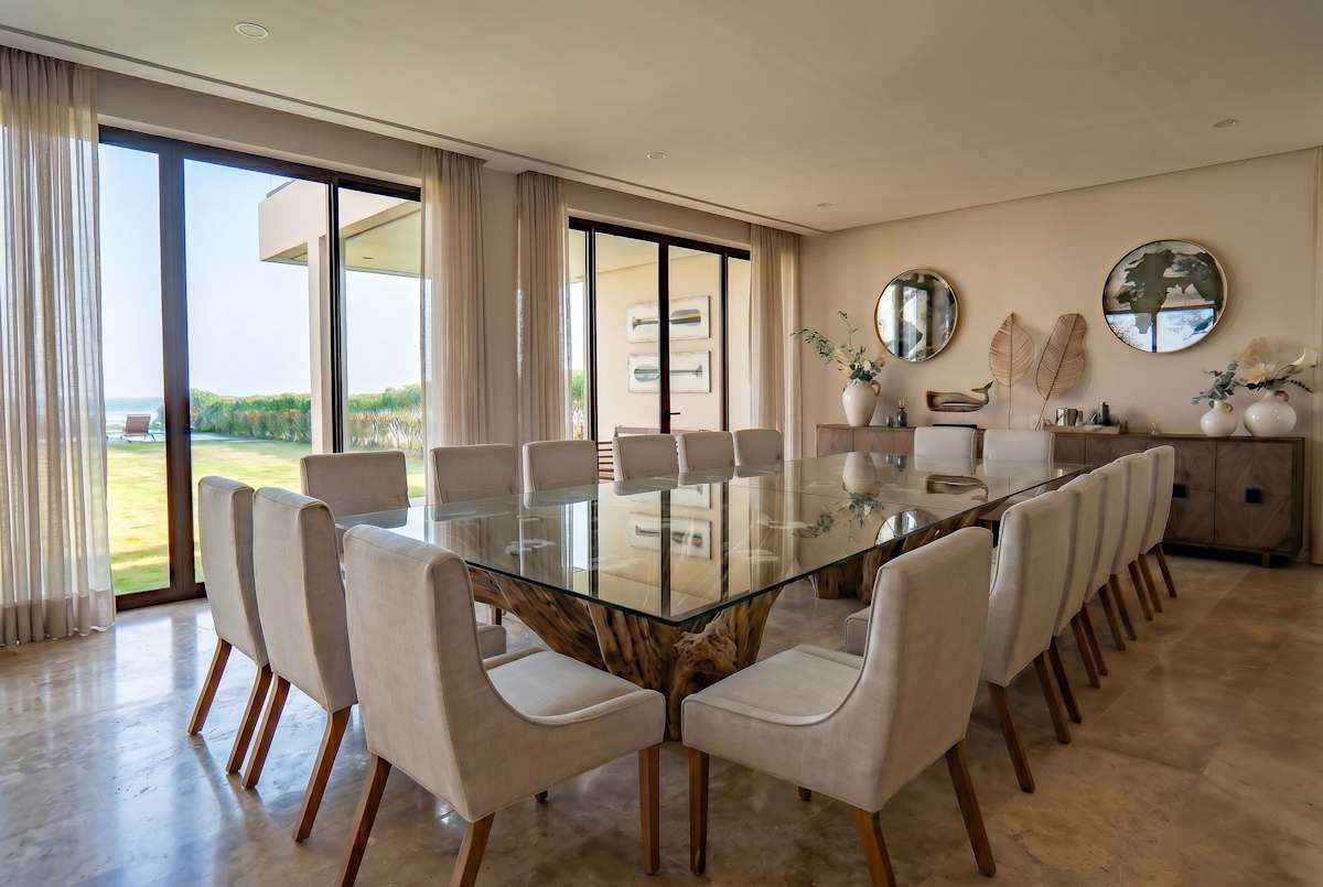 Grand formal dining room, sculptural mirrors, and walls of glass overlooking the pool and beach. Includes seating for up to 18