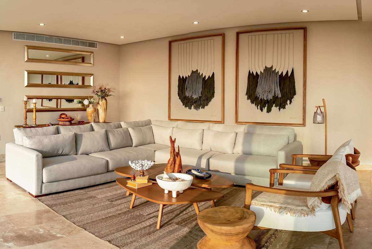 Spacious living room with plush sofas, statement artwork, and marble floors — an elegant space to relax and socialize
