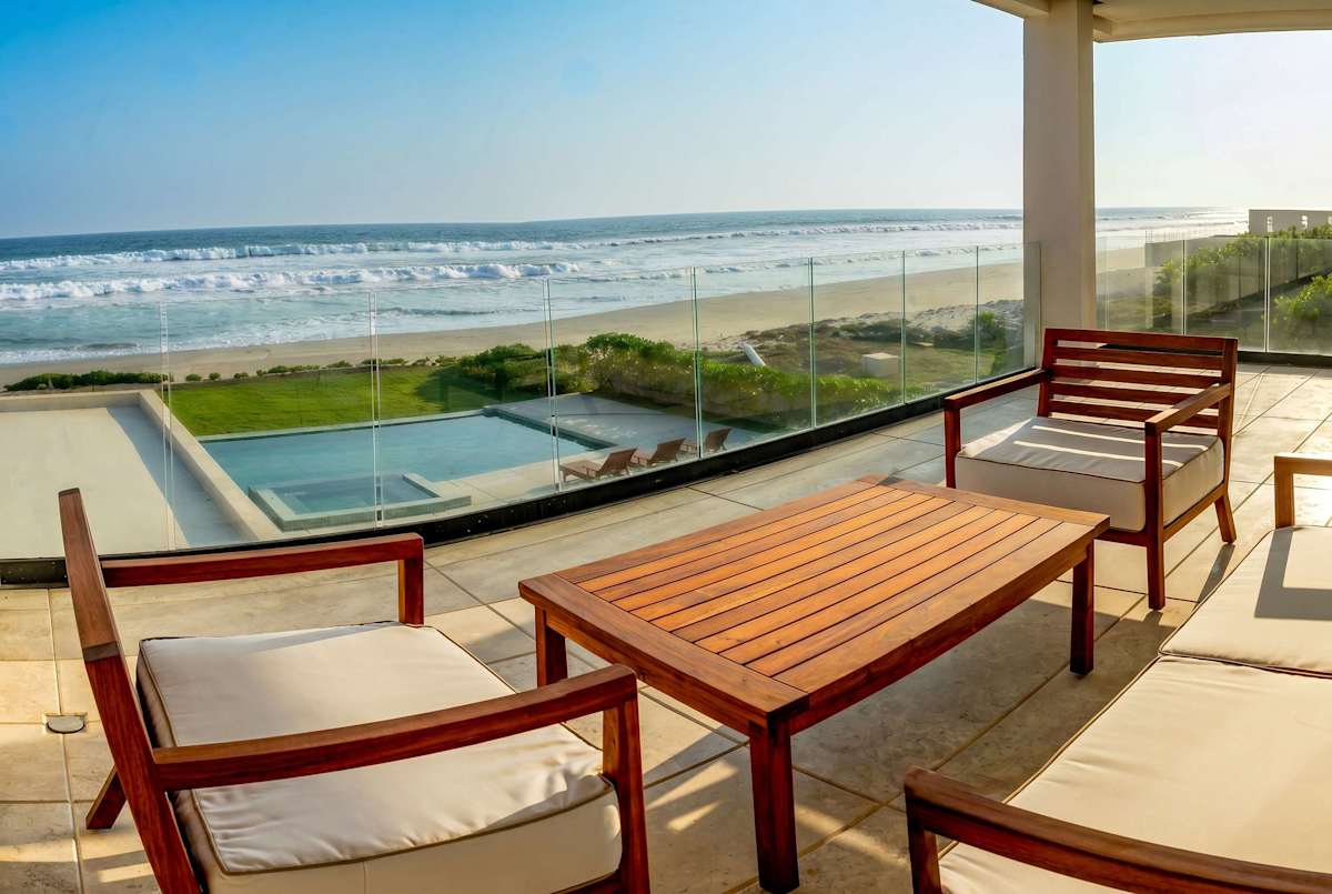 Bedroom 6 private terrace with outdoor seating, pool view, and unobstructed ocean vista — your personal outdoor paradise