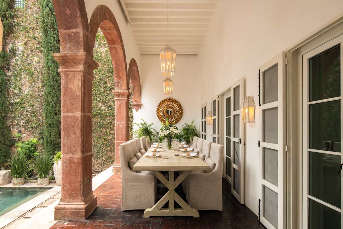 Covered outdoor dining area with long table for group meals