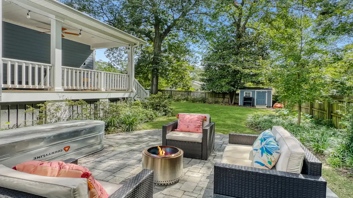 A patio area with outdoor furniture and a fire pit