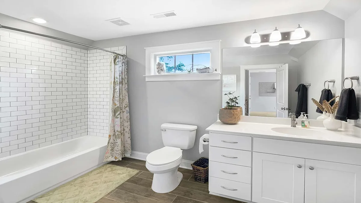 A clean and modern bathroom with a bathtub, toilet, and sink
