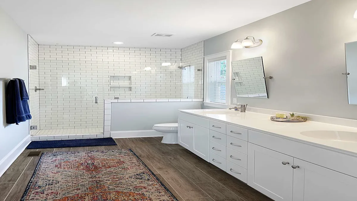 A clean and modern bathroom with a double vanity, shower, and toilet.