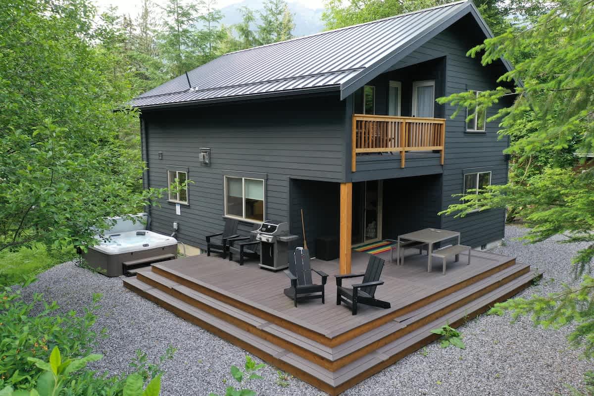 Large patio with BBQ and hit tub, your outdoor oasis awaits! 