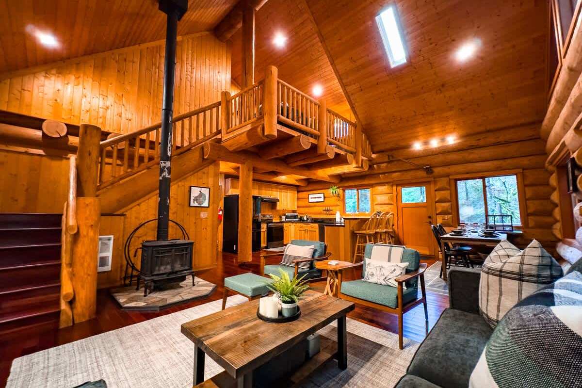 Cozy up next to the wood burning fireplace in the open layout of this stunning log home. 