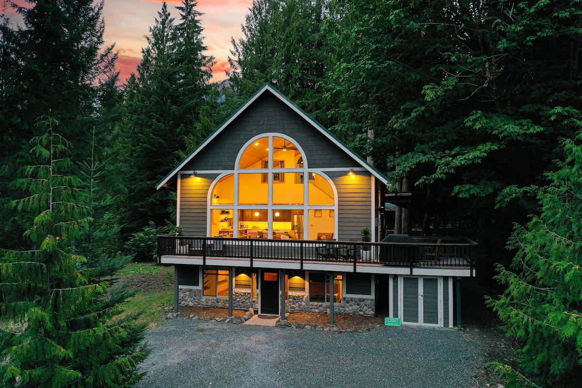 Arched windows and a vaulted roofline surrounded by the trees