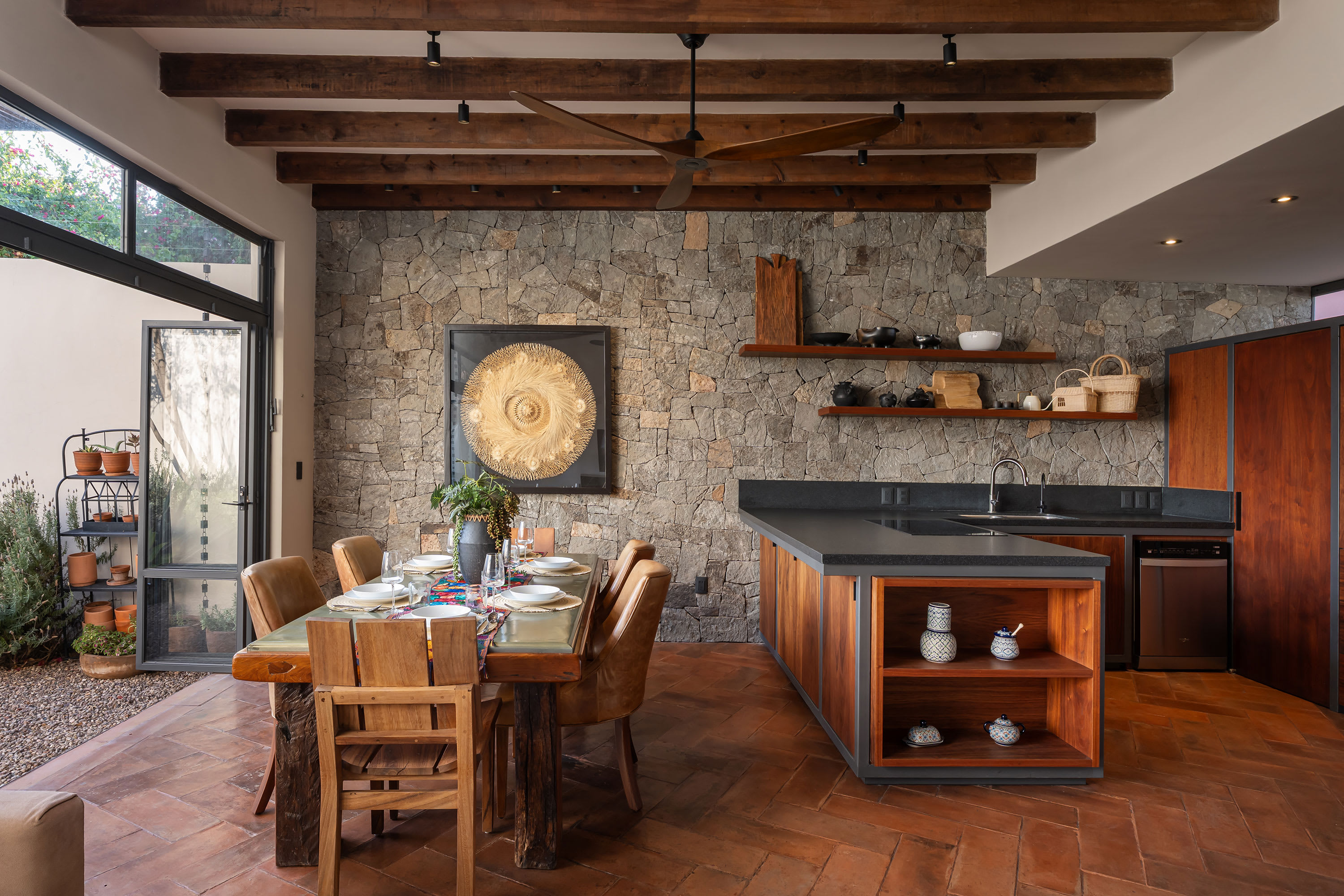 Dining area with wooden table and open kitchen