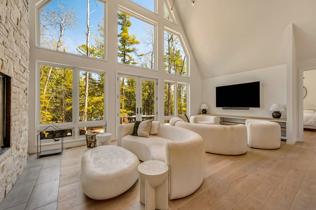 Great room with floor-to-ceiling windows at a DoCo home in Jacksonport